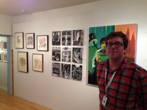 Lloyd Benjamin in his gallery's room at Aqua, with works by Benjamin Keys and Austin Eddy.