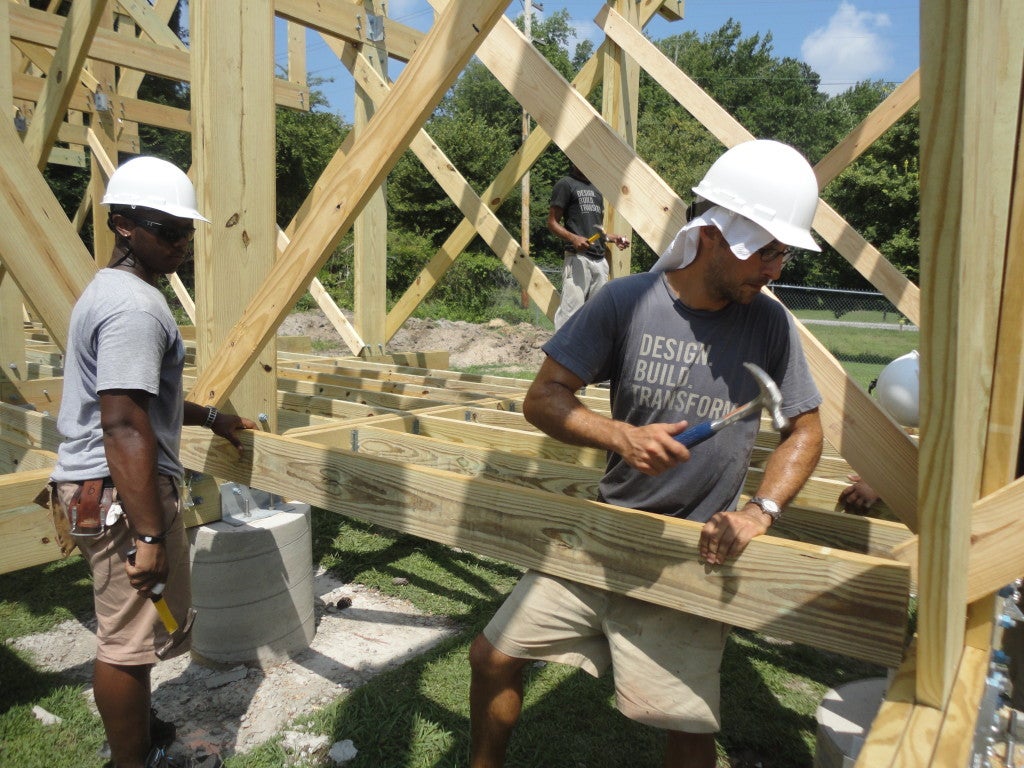 Studio H student Erick Bowen and instructor Matthew Miller working on the Windsor Farmers Market pavilion.