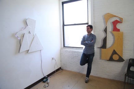 JD Walsh in his Brooklyn studio with, on left, 13/5, 2013; Hydrocol, wood, and LED lights.