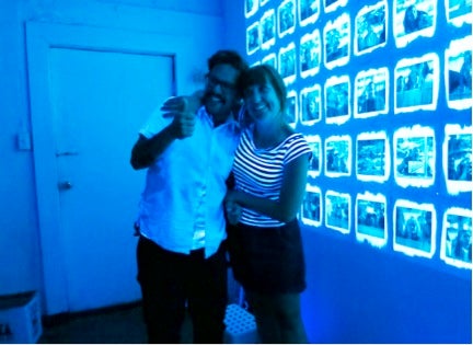 Artists Austin Eddy and Shara Hughes pose in front of Dustin Chamber’s “Installation Portraits” exhibition, 2014, Photo by Terry Kearns.