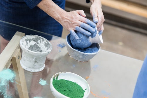 Carr adding color to one of her vessels.