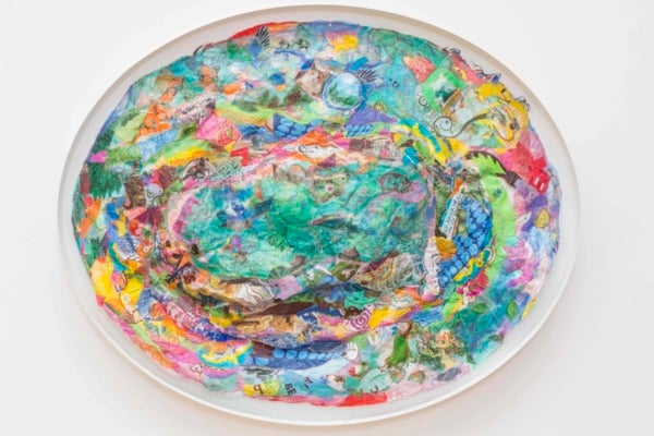 a bright, multicolored oval with swirling abstract designs and splatters