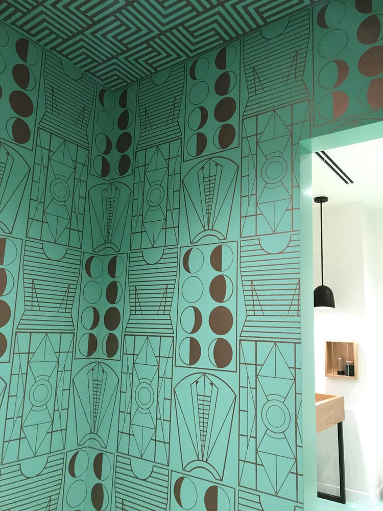 geometric pattern on a teal background
