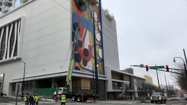 Hense mural: Workers securing the other half of the aluminum circle that was ripped off Icon Midtown tower yesterday.