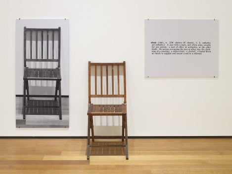 Artwork by Joesph Kosuth, photo of a chair on the wall, the actual chair sitting next to it, and a panel of text.