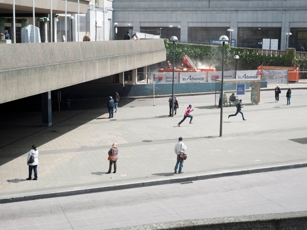 a group of people in different stages of moment are on a city street.