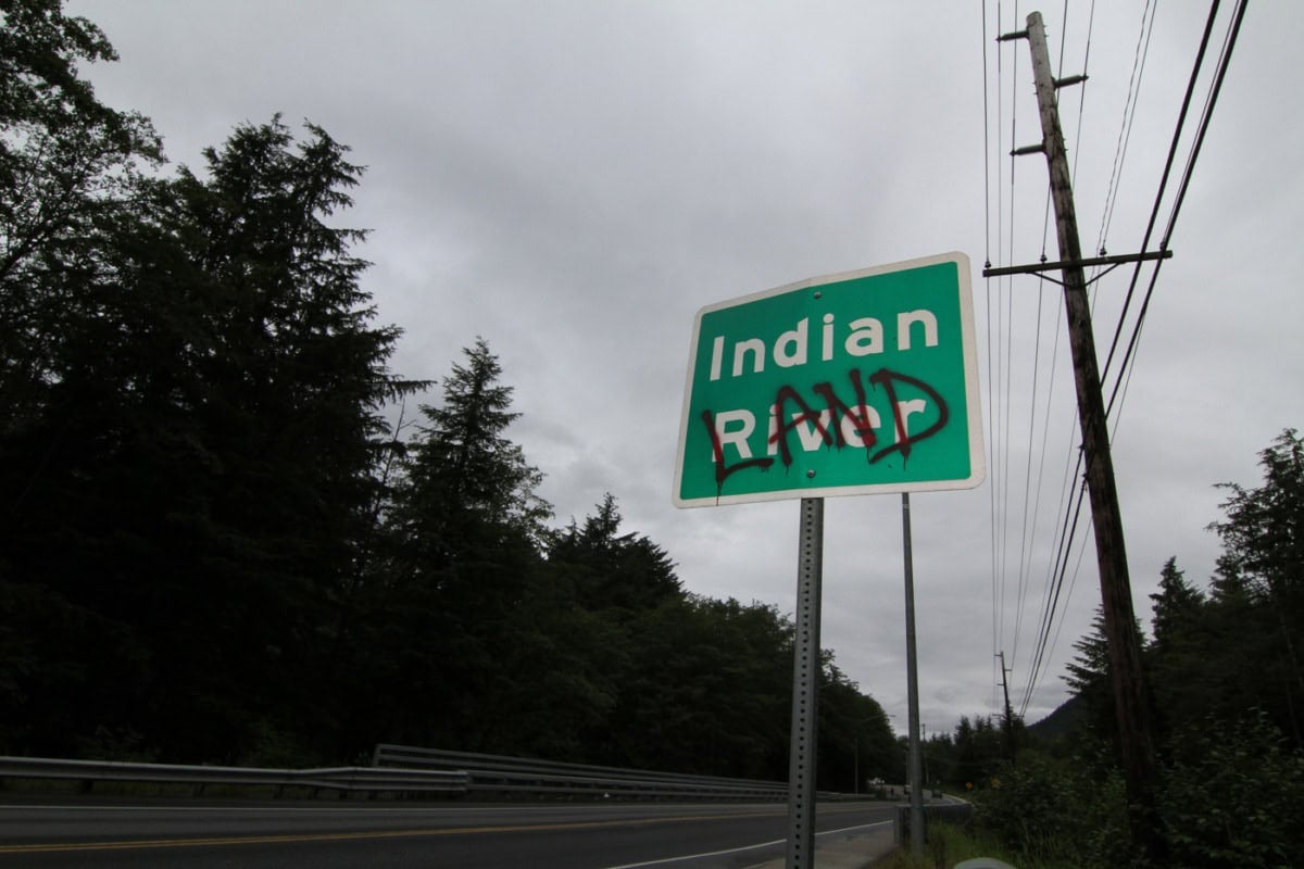 a green road sign reading 