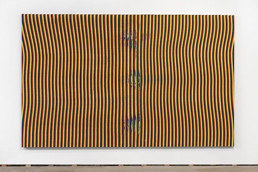 a large canvas on a white wall, on the canvas are yellow, red, and blue vertical lines, resembling electromagnetic waves