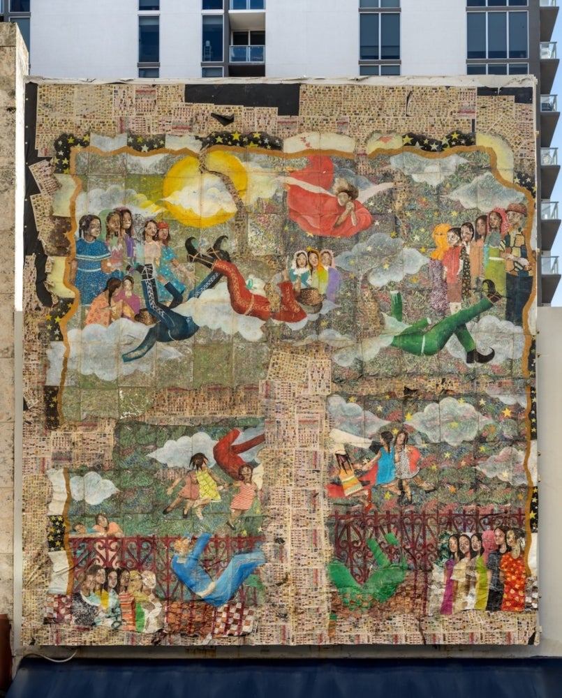 mural collage in front of high rise building tall building brown sun human figures falling