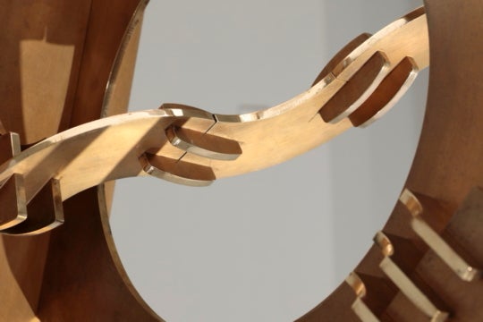 close detail of golden sculpture and negative space