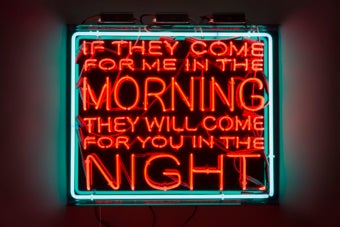 LED sign with green frame and red letters, reading 