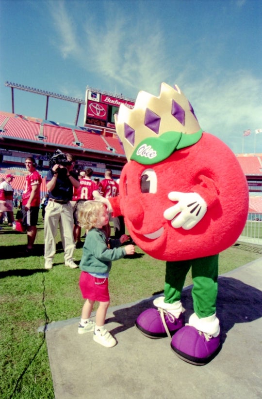 vintage image of orange mascot talking to small child